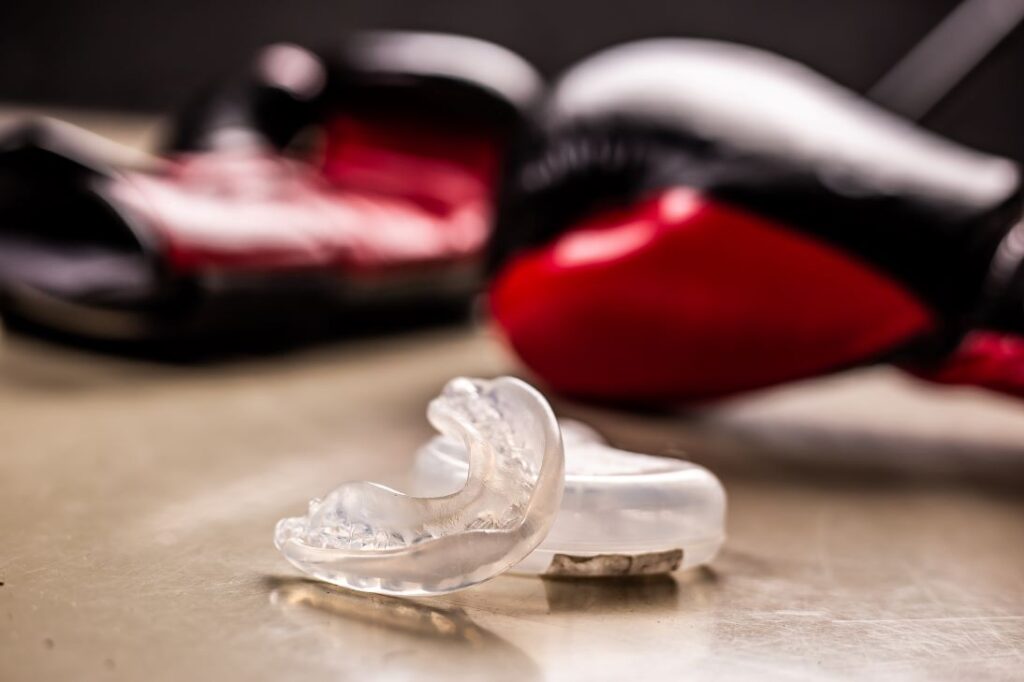 A sports mouthguard and boxing gloves